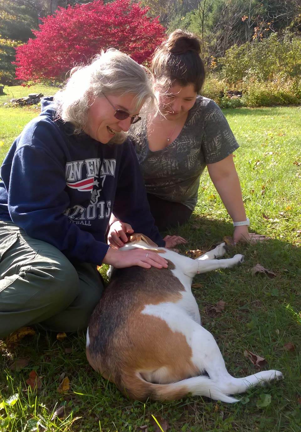 Millie laying on the grass with mom