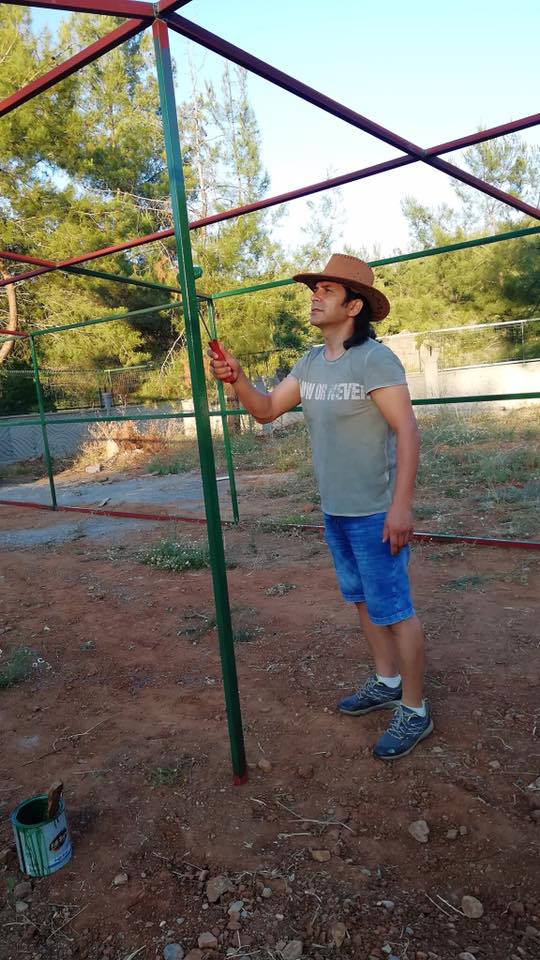 Veterinarian Dr. Osman putting the finishing touches on one of the outdoor catteries