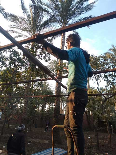 Animal rescuer constructing a new shelter structure in egypt.