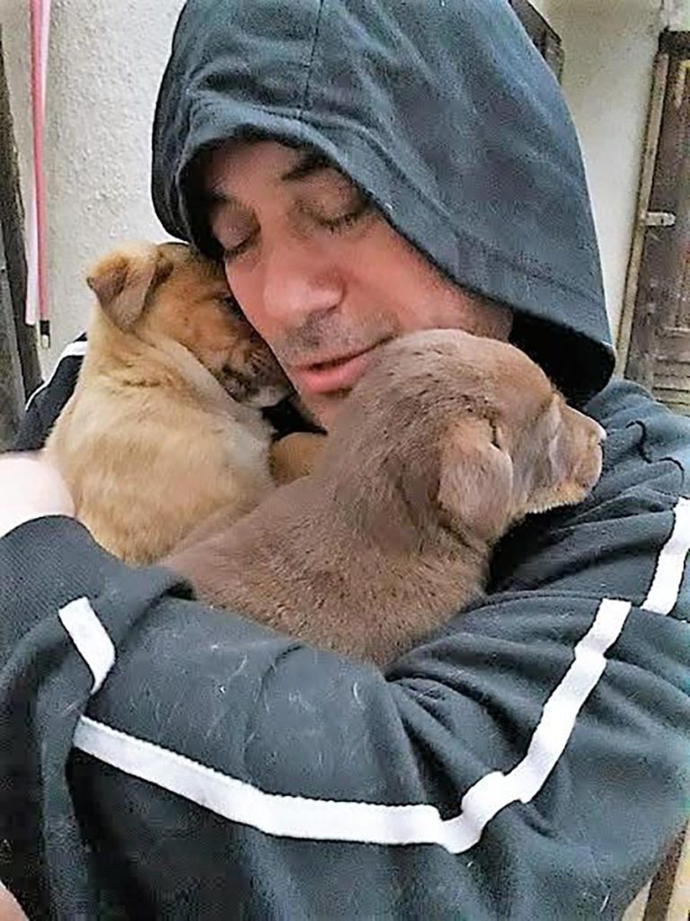 Rescuer with 2 puppies